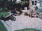 Thumbnail of the process of a block paved rear garden, brick wall including steps to new lawn.